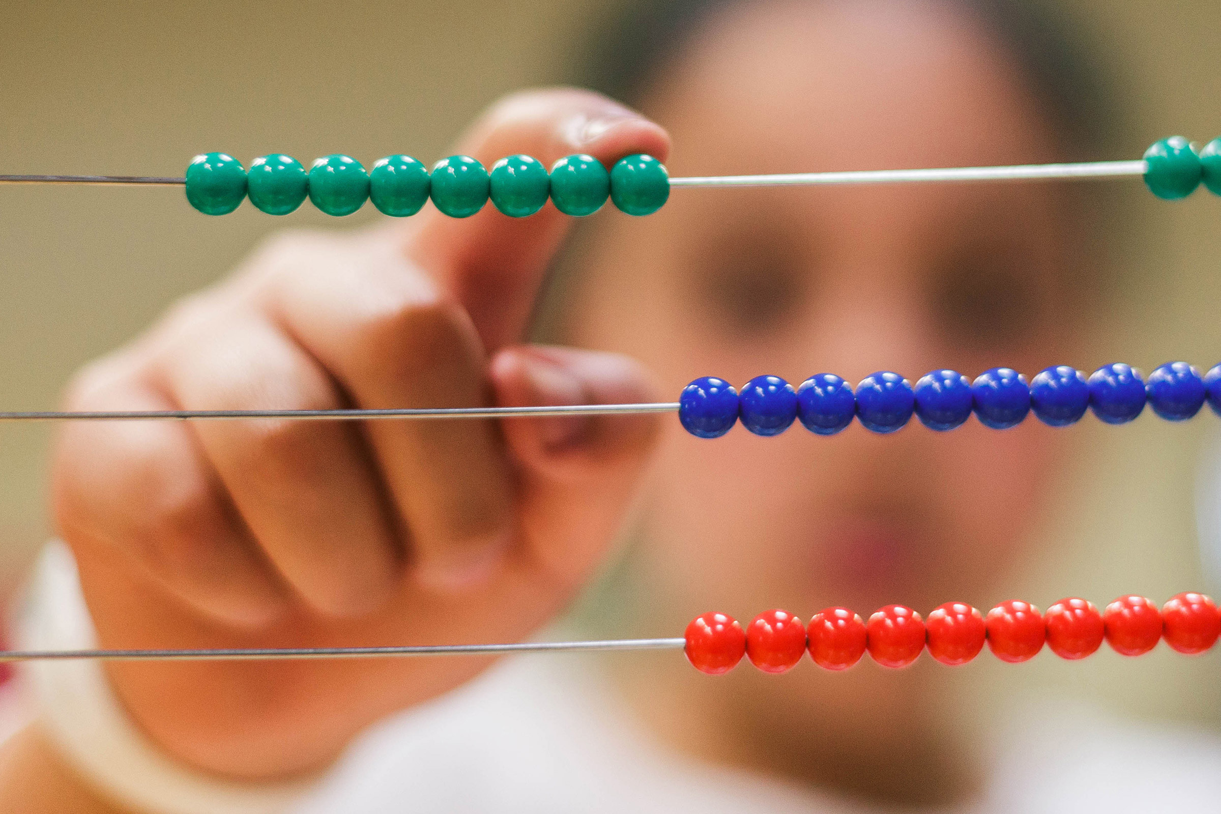 Child using Montessori bead frame material