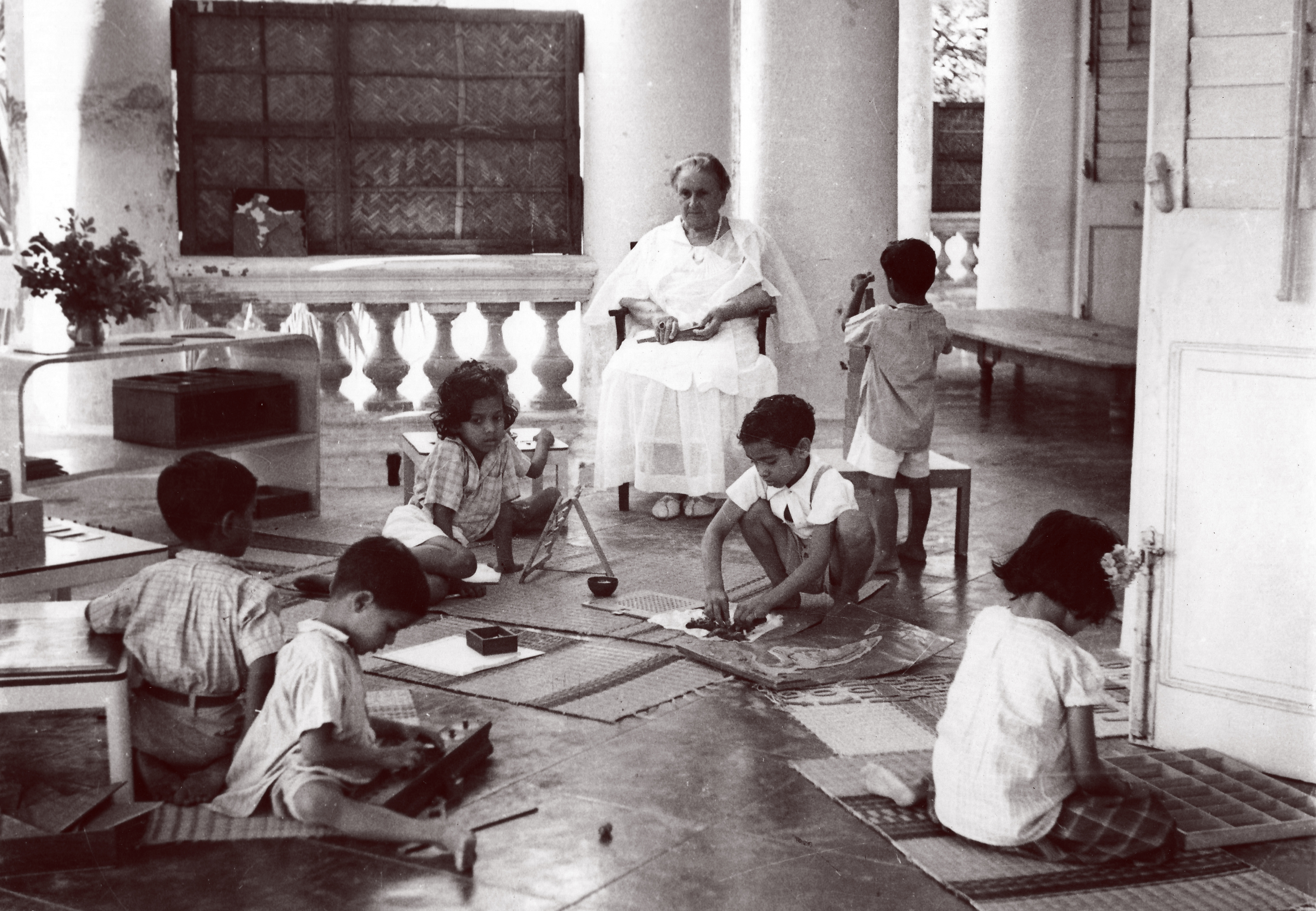 Maria Montessori observing children in school in India