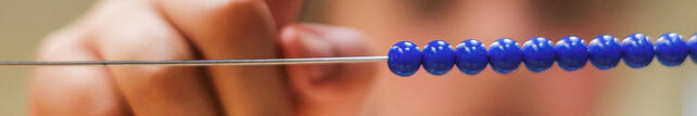 Child using Montessori bead frame material