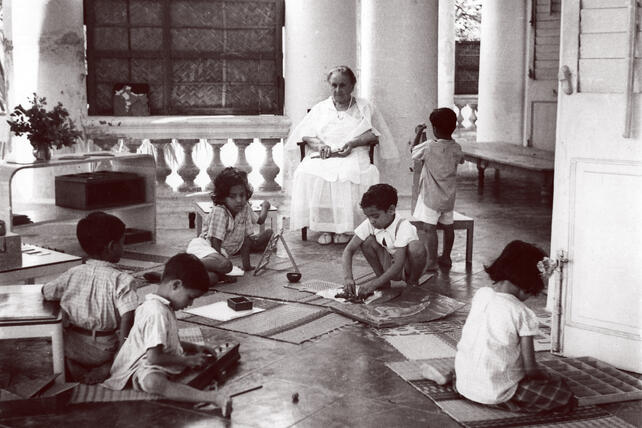 Maria Montessori observing children in school in India