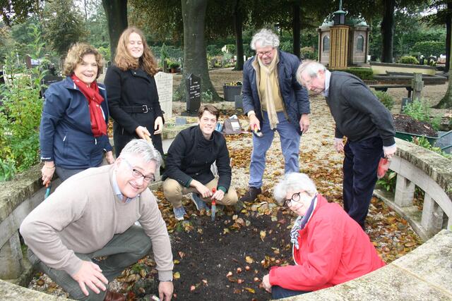 Montessori family planting tulips at Maria Montessori's grave