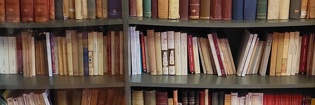 Book case of archival books in the library at AMI's office