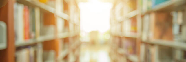 Library book shelves with sunlight beaming through