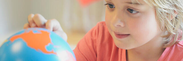 Child looking at globe